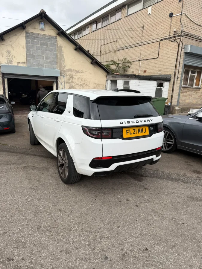 White SUV outside a workshop