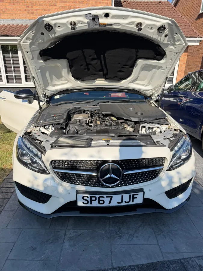 Mercedes with its bonnet open during work