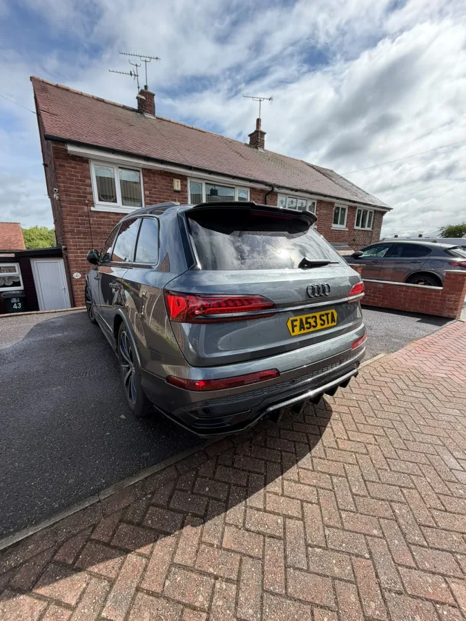 Rear view of a grey SUV parked on a driveway