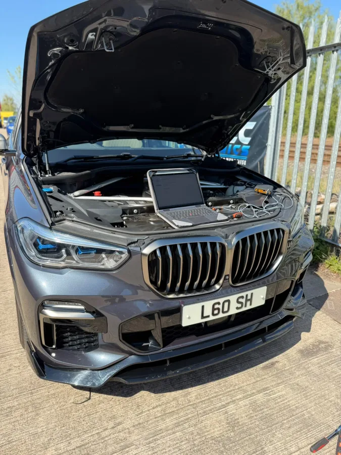 BMW with laptop connected beside the engine bay