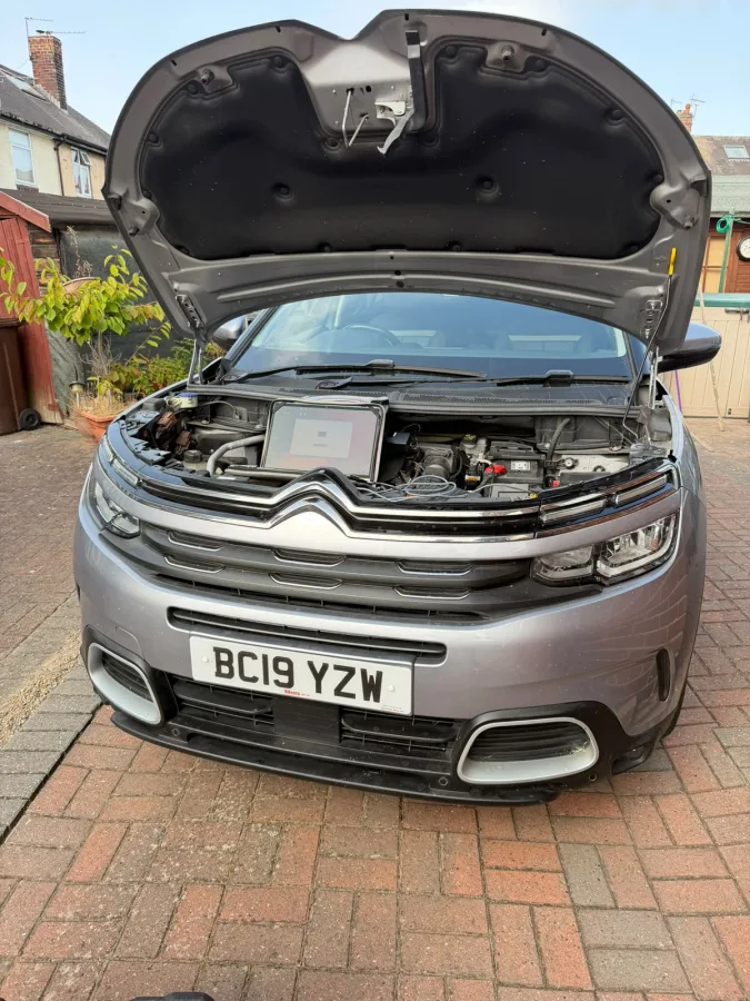 Citroën with its bonnet open and a laptop connected