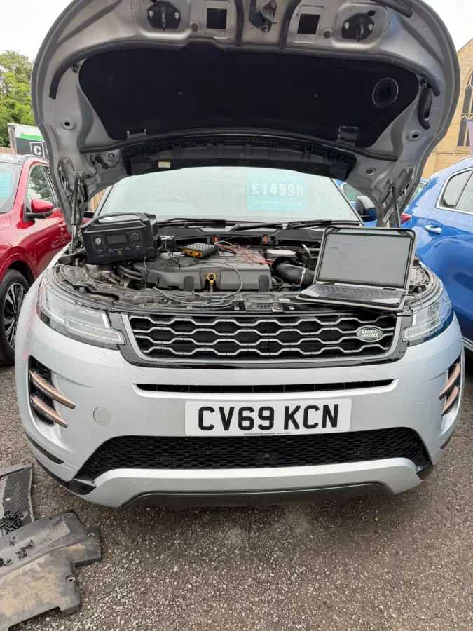 Range Rover with its bonnet open and programming equipment
