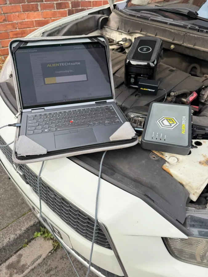 Laptop and programming equipment set up inside a vehicle