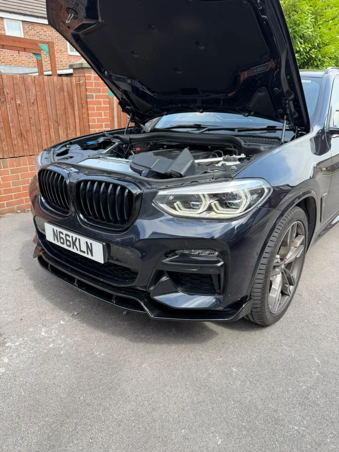 Black BMW with its bonnet open