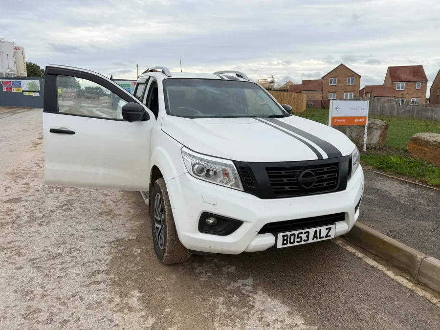 White pickup with its driver door open during a mobile visit