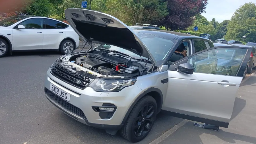 Silver SUV with its bonnet and driver door open